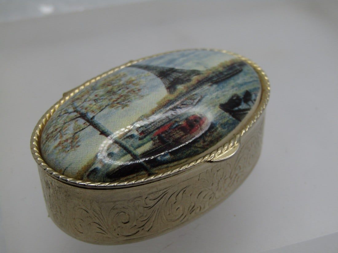 Vintage Eiffle Tower Pill Box, 1980's: Vintage Eiffle Tower Pill Box, 1980's. Tour Eiffel is writeon on the top with a domed lid with a scene with the Eiffle Tower in the background. It is 3/4" hight and 1-7/8" wide and 1.25" front-to-back