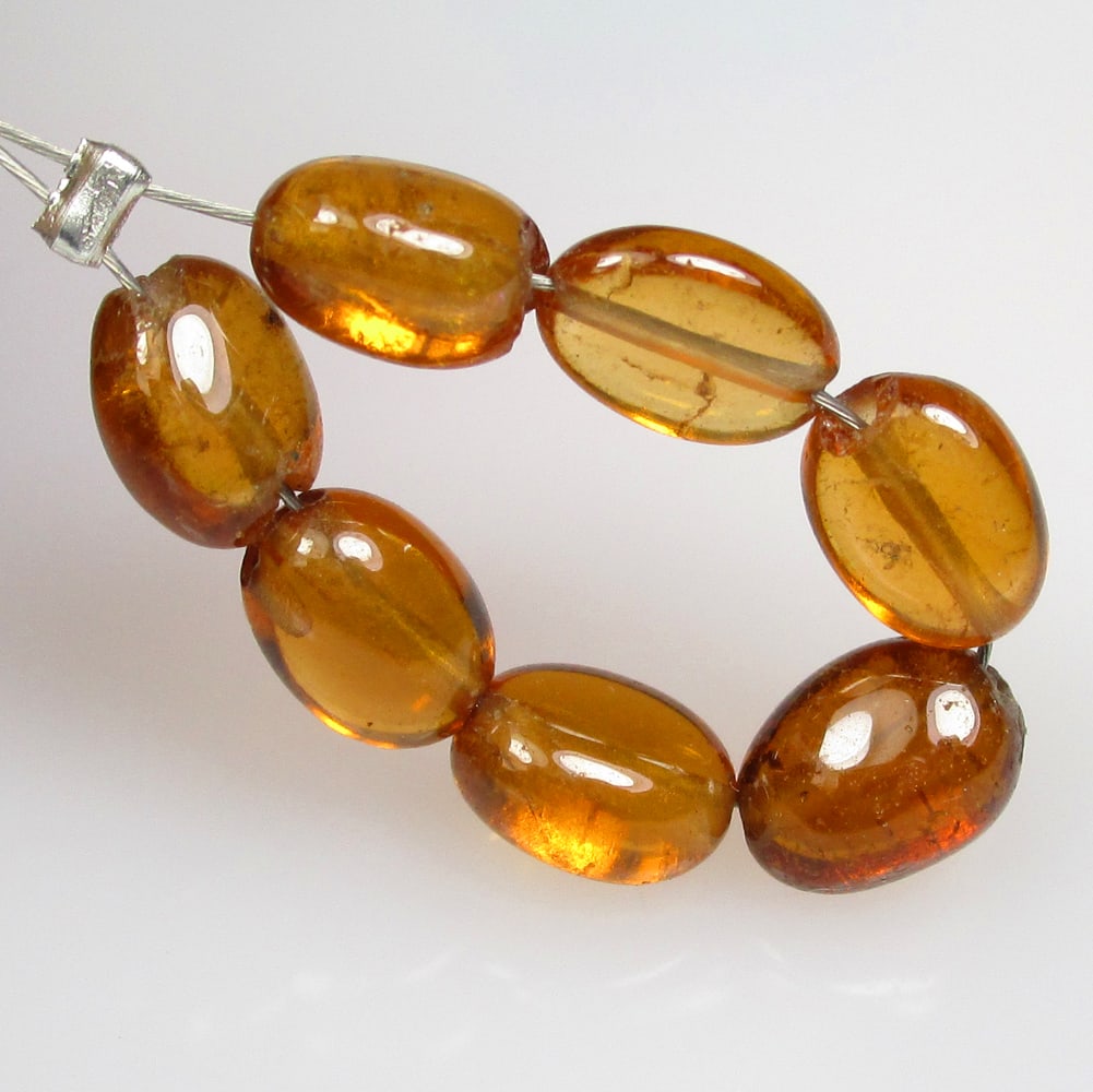 7.20 Ctw Natural 7 Hessonite Garnet Dumble Beads: No Reserve! Title: 7.20 Ctw Natural 7 Hessonite Garnet Dumble Beads Stone Clarity: Transparent Gemstones: Natural Hessonite Garnet Beads Carat Weights: 7.2 Size/Dimensions: 4.7x3.0- 5.2x3.3 mm / 7 Pc'