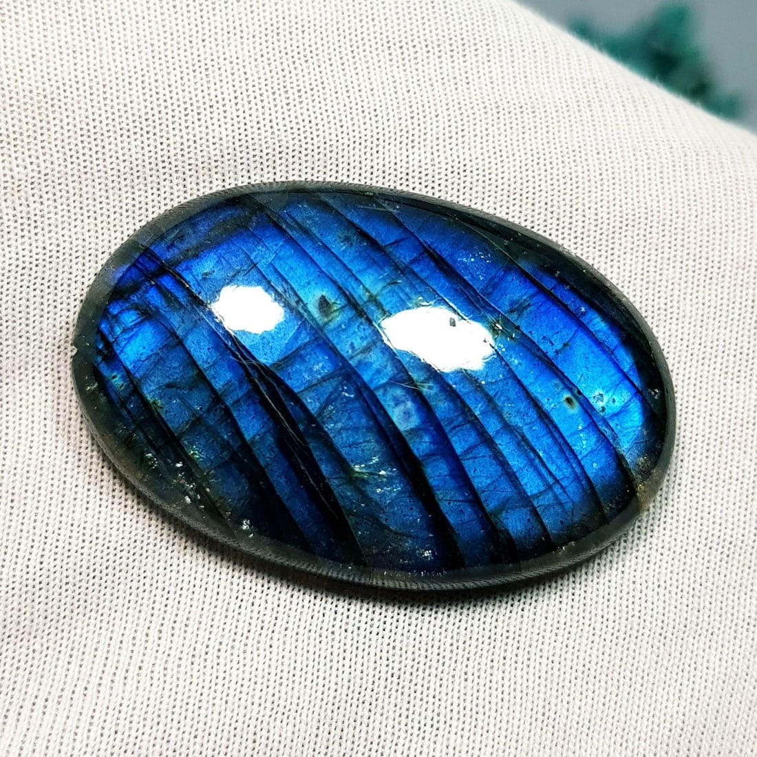 53.35 Ctz Natural Blue Labradorite: No Reserve! Title: 53.35 Ctz Natural Blue Labradorite Color/Clarity: Bluish / Semi Transparent Gemstone: Labradorite Carat Weights: 53.35 Size: 36.00 x 23.20 x 8.00 Additional Information: Oval Caboch
