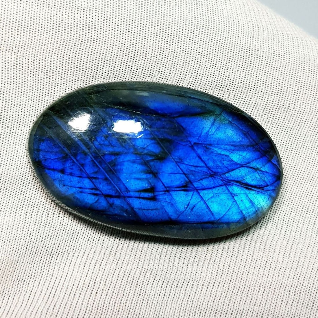 58.45 Ctz Natural Blue Labradorite: No Reserve! Title: 58.45 Ctz Natural Blue Labradorite Color/Clarity: Bluish / Semi Transparent Gemstone: Labradorite Carat Weights: 58.45 Size: 37.85 x 22.55 x 8.00 Additional Information: Oval Caboch