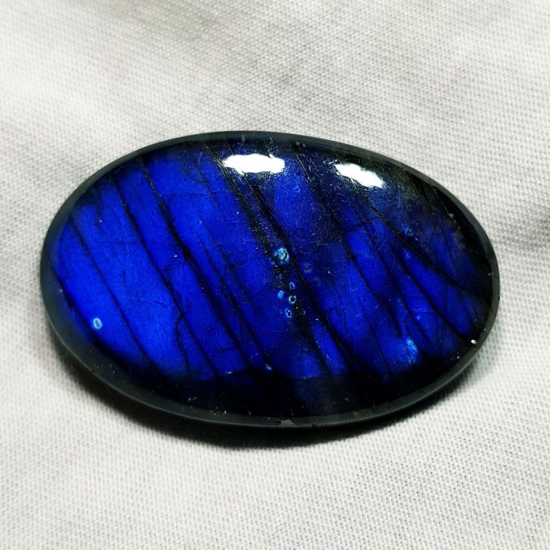 67.82 Ctz Natural Blue Labradorite: No Reserve! Title: 67.82 Ctz Natural Blue Labradorite Color/Clarity: Bluish / Semi Transparent Gemstone: Labradorite Carat Weights: 67.82 Size: 37.25 x 24.10 x 8.40 Additional Information: Oval Caboch