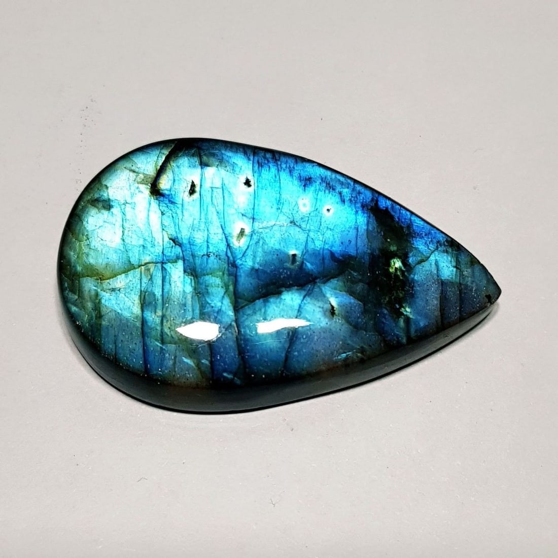 77.43 Ctz Natural Blue Labradorite: No Reserve! Title: 77.43 Ctz Natural Blue Labradorite Color/Clarity: Bluish / Semi Transparent Gemstone: Labradorite Carat Weights: 77.43 Size: 43.20 x 27.30 x 8.00 Additional Information: Pear Caboch