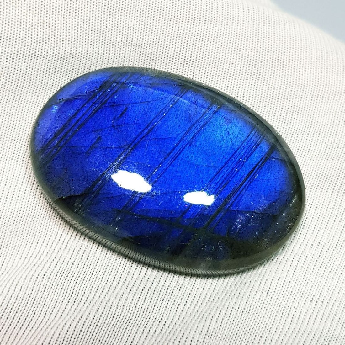 66.80 Ctz Natural Blue Labradorite: No Reserve! Title: 66.80 Ctz Natural Blue Labradorite Color/Clarity: Bluish / Semi Transparent Gemstone: Labradorite Carat Weights: 66.8 Size: 36.95 x 25.35 x 8.00 Additional Information: Oval Cabocho