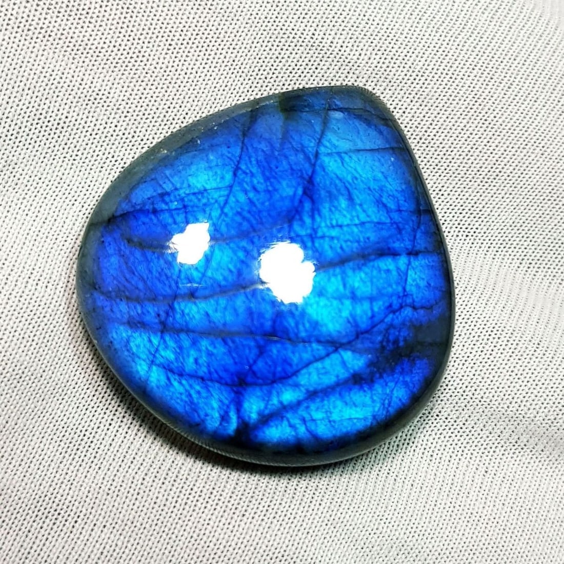 57.28 Ctz Natural Blue Labradorite: No Reserve! Title: 57.28 Ctz Natural Blue Labradorite Color/Clarity: Bluish / Semi Transparent Gemstone: Labradorite Carat Weights: 57.28 Size: 30.95 x 29.20 x 7.70 Additional Information: Pear Caboch