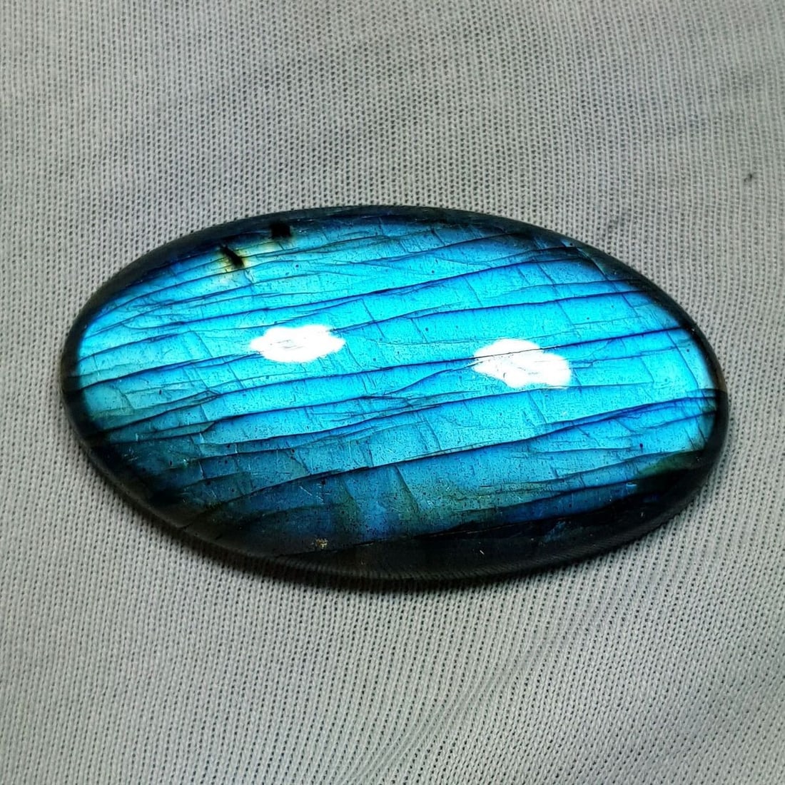 62.43 Ctz Natural Blue Labradorite: No Reserve! Title: 62.43 Ctz Natural Blue Labradorite Color/Clarity: Bluish / Semi Transparent Gemstone: Labradorite Carat Weights: 62.43 Size: 42.55 x 24.45 x 7.20 Additional Information: Oval Caboch