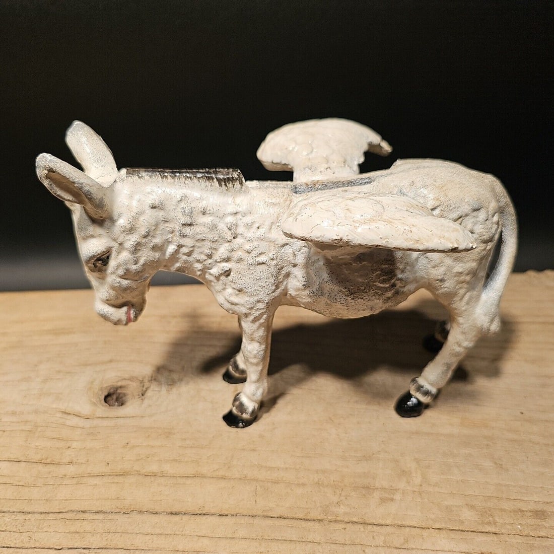 Cast Iron Flying Donkey Coin Bank: 7" Long x 5 1/4" Tall 4 1/5" Wide Great reproduction folk art cast iron mechanical coin bank. This piece was made to look just like an antique, but is actually new. Great realistic hand painted and di