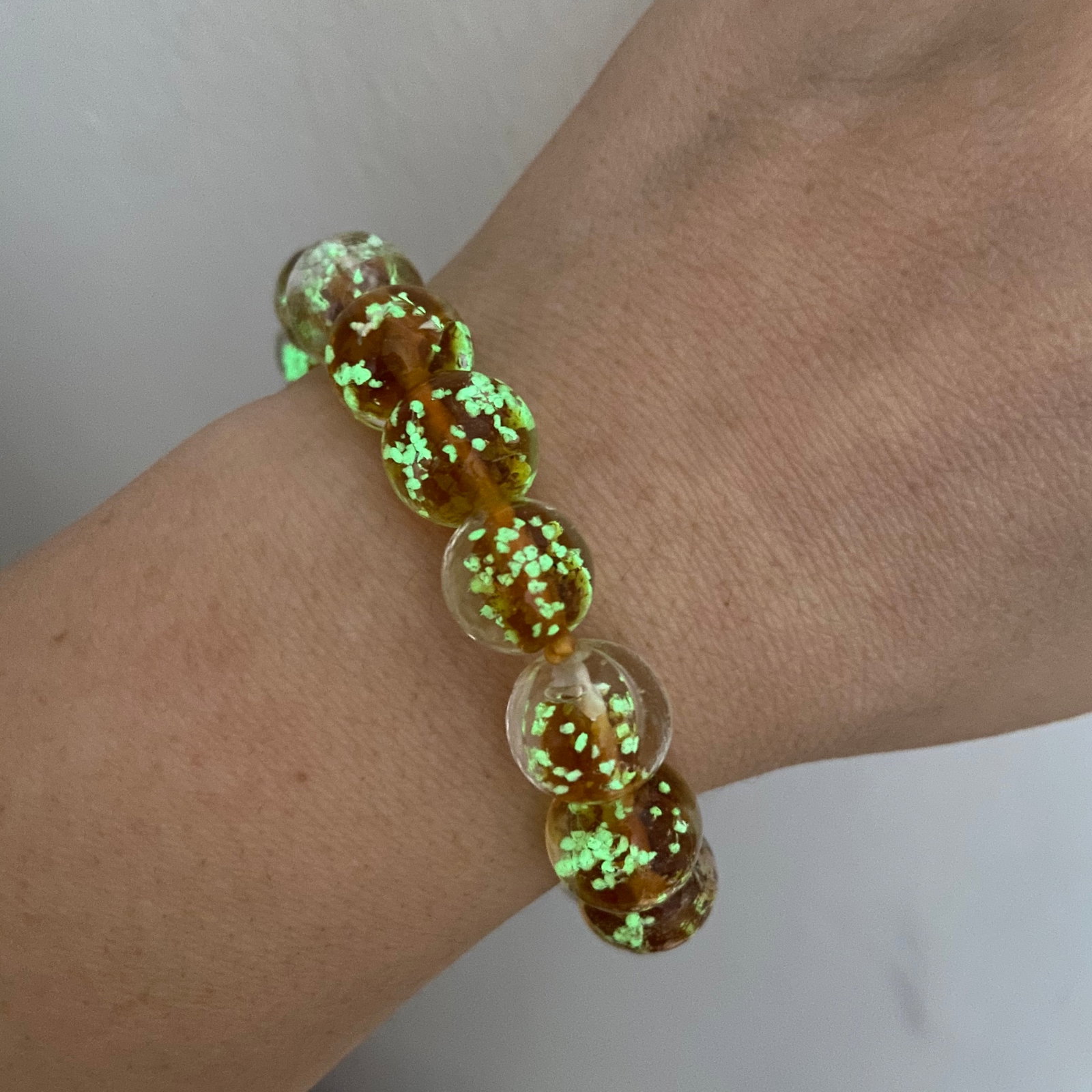Fluorescence Peking Glass Mystic Bead Stretch Bracelet: Fluorescence Peking Glass Mystic Bead Stretch Bracelet These 12mm Peking glass beads are designed in a way to give off the beautiful shimmer of the glass just like in the photo. The bracelet truly shi