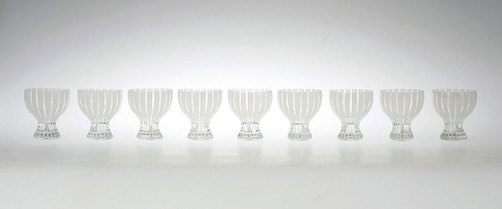 9 Cocktail Glass "Strict", Bengt Orup, Johansfors.: Title: 9 Cocktail Glass "Strict", Bengt Orup, Johansfors. 9 Cocktail Glass "Strict", Bengt Orup, Johansfors. 1950s. White. Height 8 cm. In good condition, 2 glass with a crack. Reserve: $525.00 Shippi