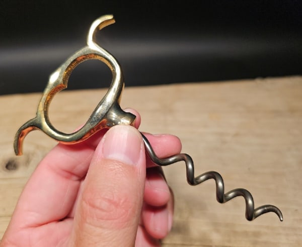 Brass & Iron Direct pull Corkscrew: 4 3/4" long x 3" wide Beautifully designed and functional reproduction tool used for removing corks from wine bottles. It embodies the charm and elegance of antique corkscrews while incorporating mode