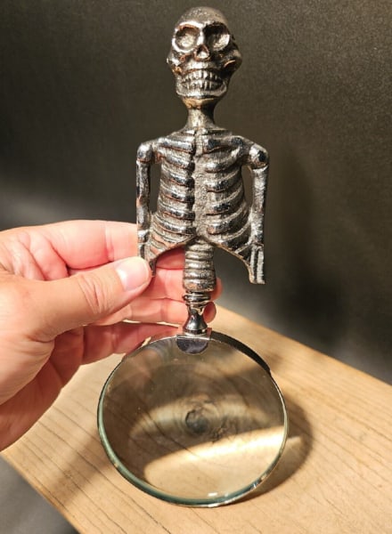 Skeleton Magnifying Glass Desk Hand Lens: 9-1/2" in length and a 4" diameter 5X lens Such a neat reproduction magnifying glass. The handle is all metal and aged to look old. The magnifying glass functions as it should. Makes a great accent or