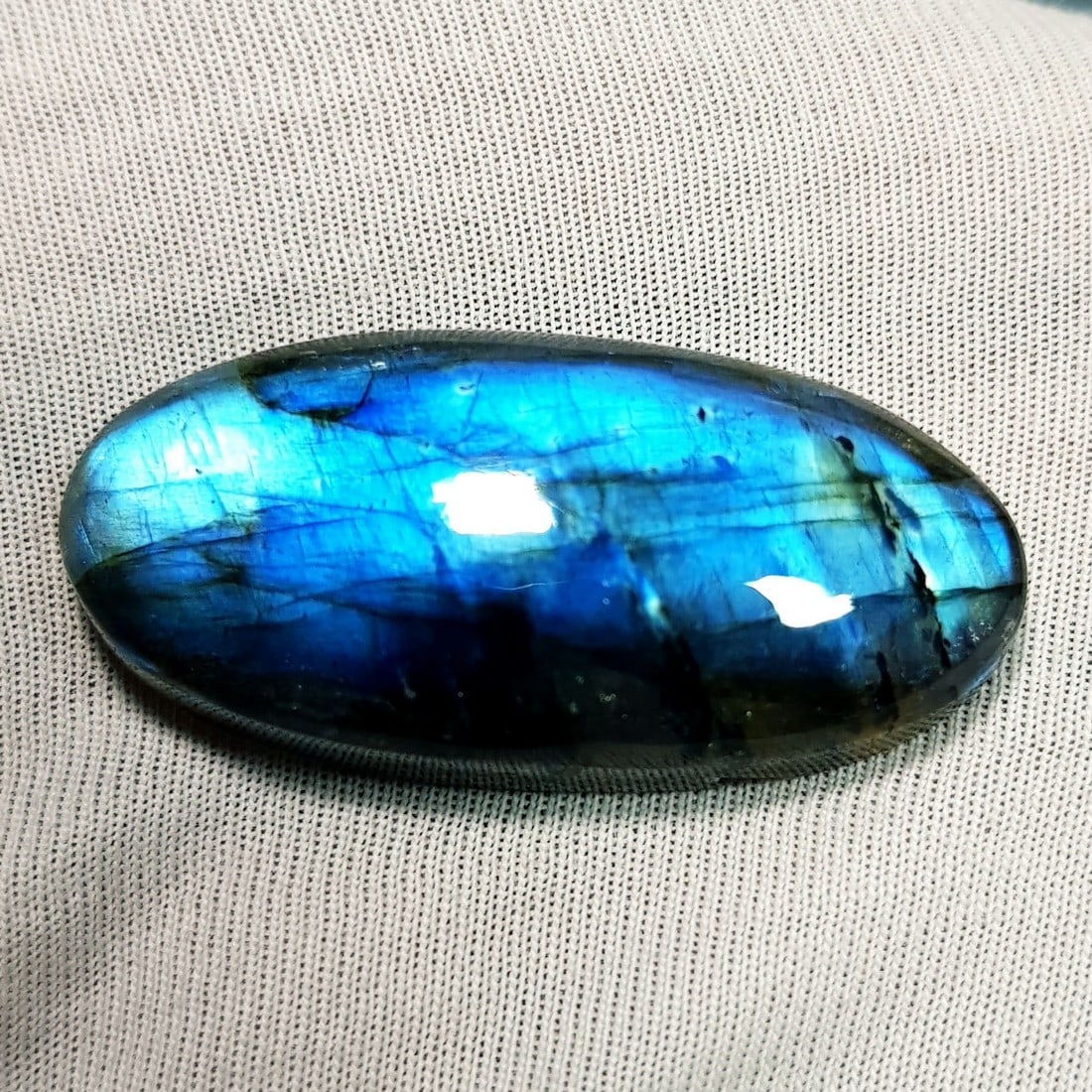48.25 Ctz Natural Blue Labradorite: No Reserve! Title: 48.25 Ctz Natural Blue Labradorite Color/Clarity: Bluish / Semi Transparent Gemstone: Labradorite Carat Weights: 48.25 Size: 38.00 x 18.10 x 8.00 Additional Information: Oval Caboch