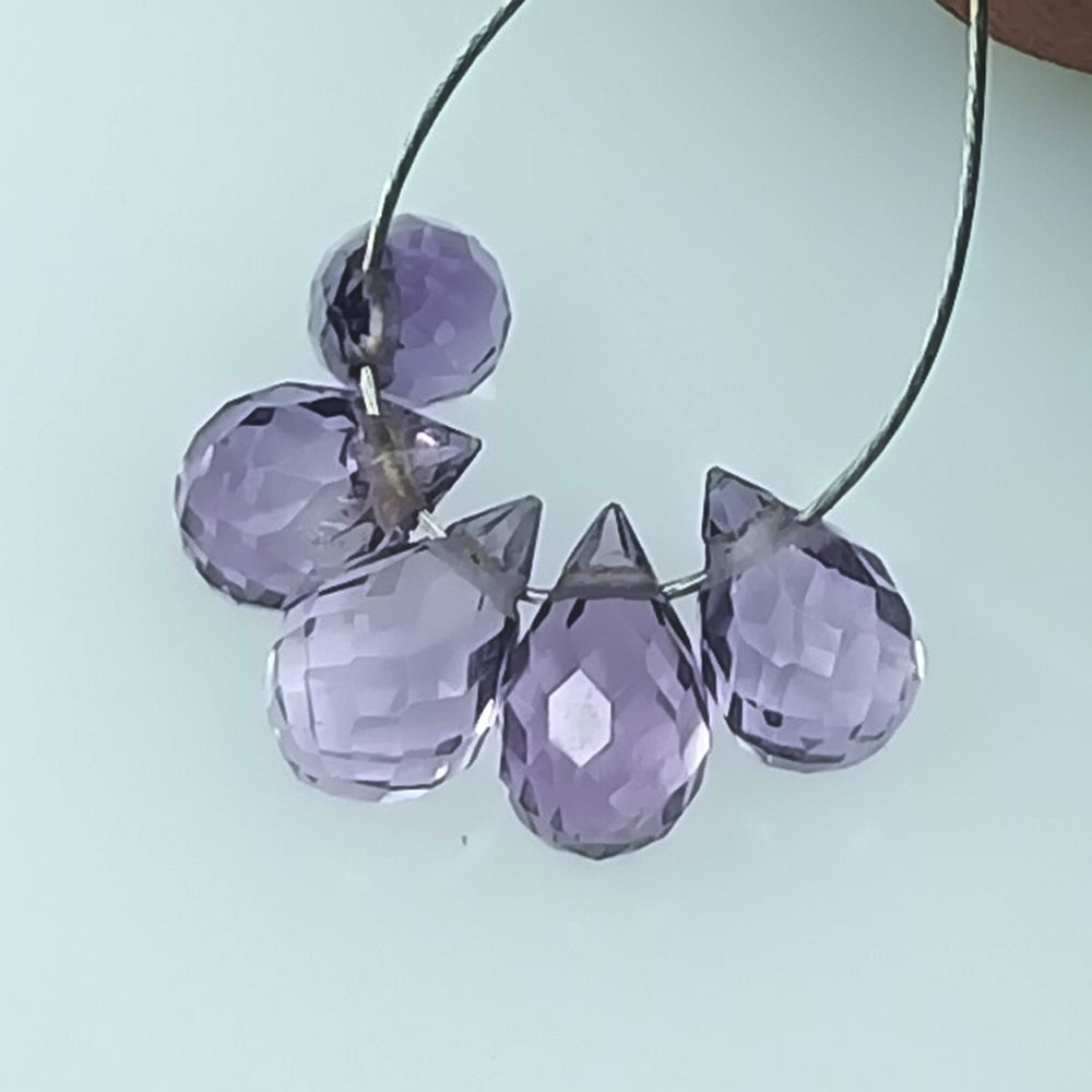 2.64 Ctw Natural 5 Drilled Purple Amethyst Pear Drop Beads: No Reserve! Title: 2.64 Ctw Natural 5 Drilled Purple Amethyst Pear Drop Beads Stone Clarity: Transparent Gemstones: Natural Amethyst Beads Carat Weights: 2.64 Size/Dimensions: 6.0x3.2 - 6.5x3.3 mm / 5