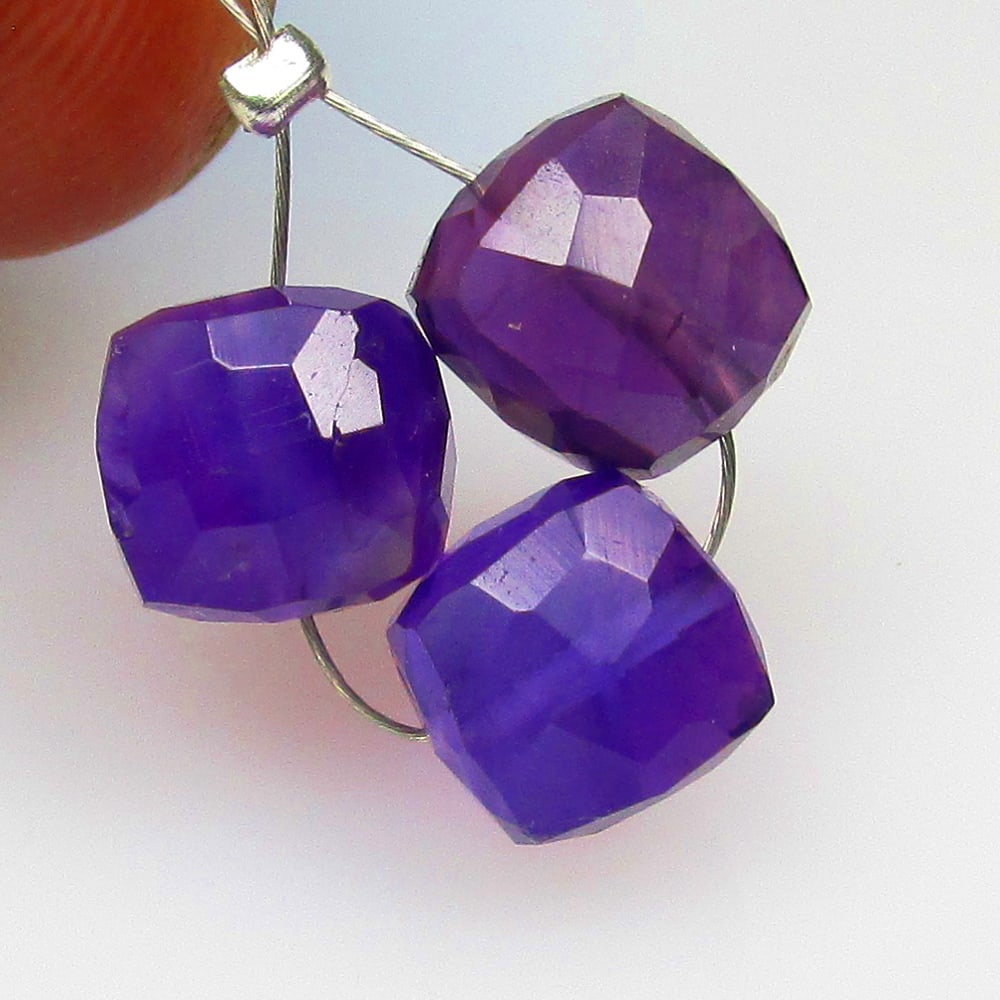 10.14 Ctw Natural 3 Drilled Purple Amethyst Square Beads: No Reserve! Title: 10.14 Ctw Natural 3 Drilled Purple Amethyst Square Beads Stone Clarity: Transparent Gemstones: Natural Amethyst Beads Carat Weights: 10.14 Size/Dimensions: 7.4x7.4 - 7.7x7.7 mm / 3
