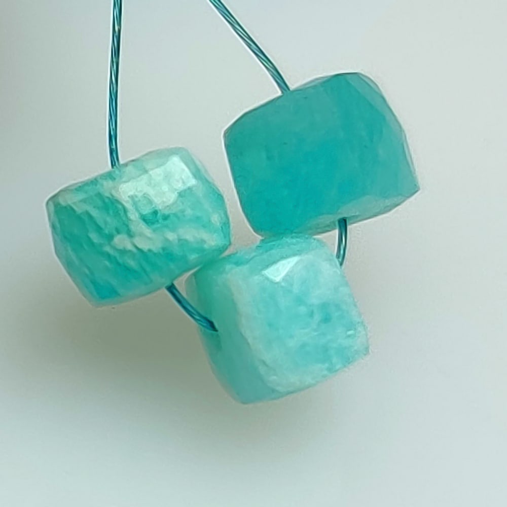 4.86 Ctw Natural 3 Drilled Amazonite Square Beads: No Reserve! Title: 4.86 Ctw Natural 3 Drilled Amazonite Square Beads Stone Clarity: Opaque Gemstones: Natural Amazonite Beads Carat Weights: 4.86 Size/Dimensions: 5.9x5.9 to 6.2x6.2 mm / 3 PC's Additi