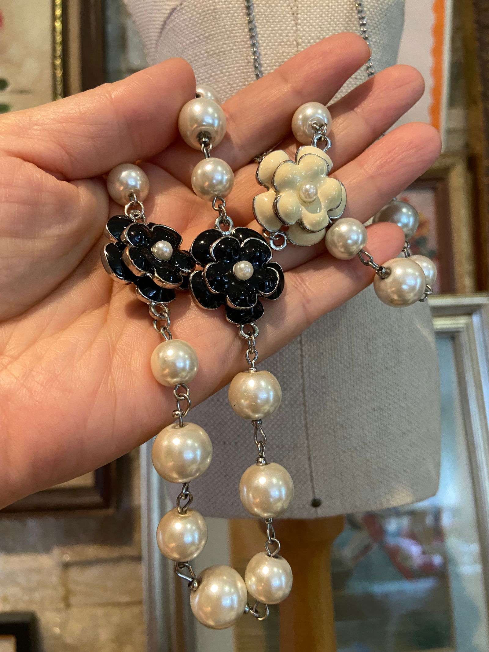Vintage Chanel's camellia style white pearl chain dressing necklace: Title: Vintage Chanel's camellia style white pearl chain dressing necklace Additional Information: This long dressing necklace emulates the timeless elegance of Chanel's camellia white pearl chain. Fe