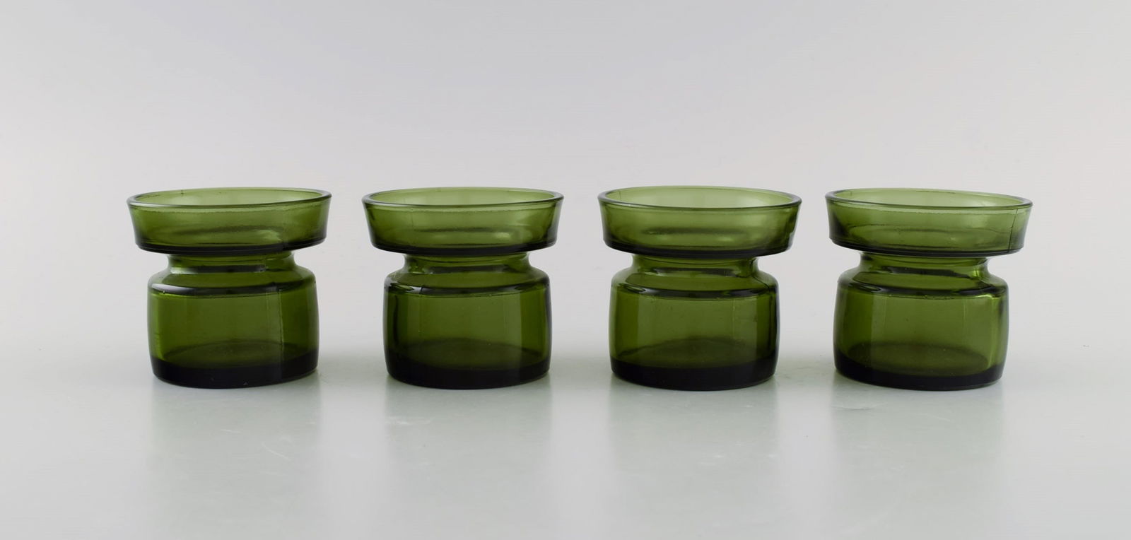 Jens Harald Quistgaard. Four "Hygge" light holders for teacandles in dark green art glass. Retro, (1 of 6)