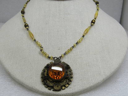 Vintage Czech Glass Beaded Necklace 17": Vintage Czech Glass Beaded Necklace 17". Signed on the jump ring what appears to be Czechoslovakia but slightly shortened. Brassy gold tone pendant and spring clasp with an amber colored faceted stone