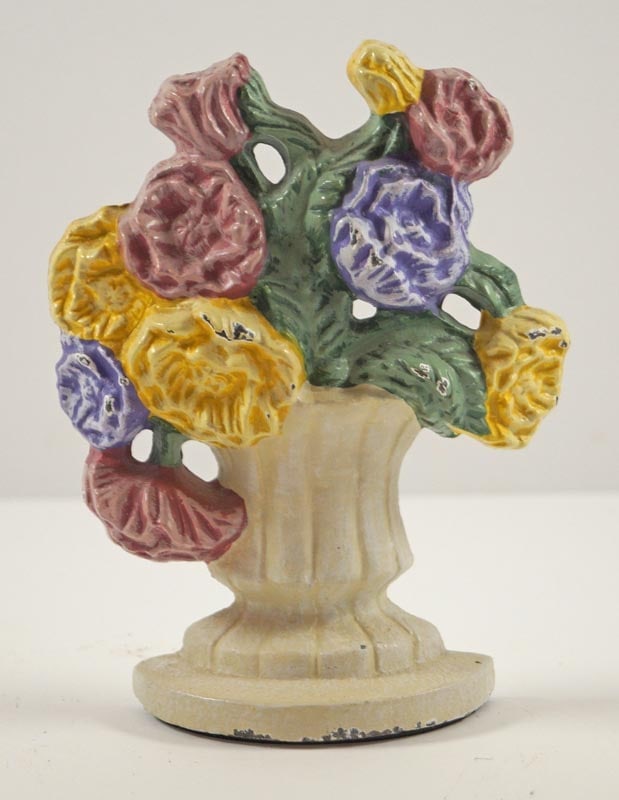 Mixed Flowers in Urn Cast Iron Doorstop: Title: Mixed Flowers in Urn Cast Iron Doorstop Dimension: 5 1/8" tall x 3 7.8" wide x 3 1/4" deep including wedge. Date: Circa 1980's. Additional Information: Miniature Mixed Flowers in Urn cast iron 
