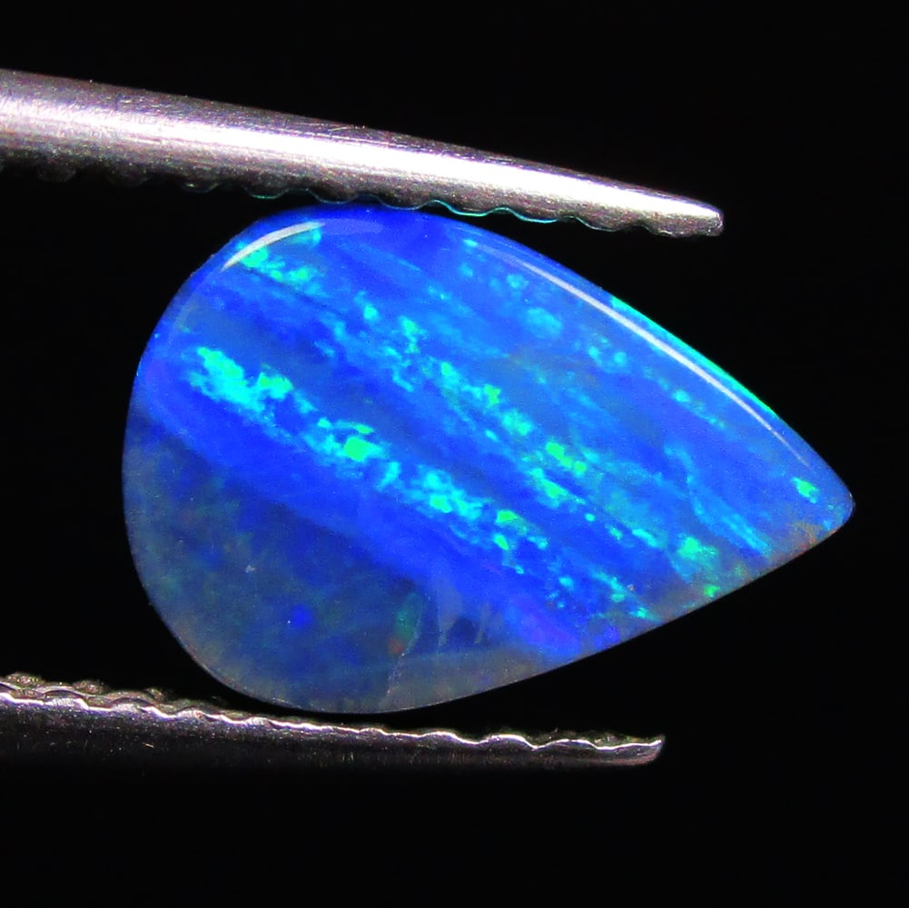1.45 Ctw Natural Australian Doublet Opal Pear Cabochon: No Reserve! Title: 1.45 Ctw Natural Australian Doublet Opal Pear Cabochon Stone Clarity: Opaque Gemstones: Natural Australian Opal Carat Weights: 1.45 Size/Dimensions: 9.30 x 6.50 x 3.00 mm Additional