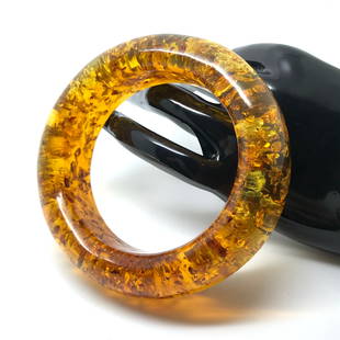 Phenomenal Vintage Amber Bangle Bracelet: Title: Phenomenal Vintage Amber Bangle Bracelet Metal: None Gemstone: Amber Weight: 62.96 g Dimensions: Inner diameter: 59.40 mm Size: 23.60 x 86.75 x 14.15 mm Size: 0.929 x 3.415 x 0.557 inches Inner