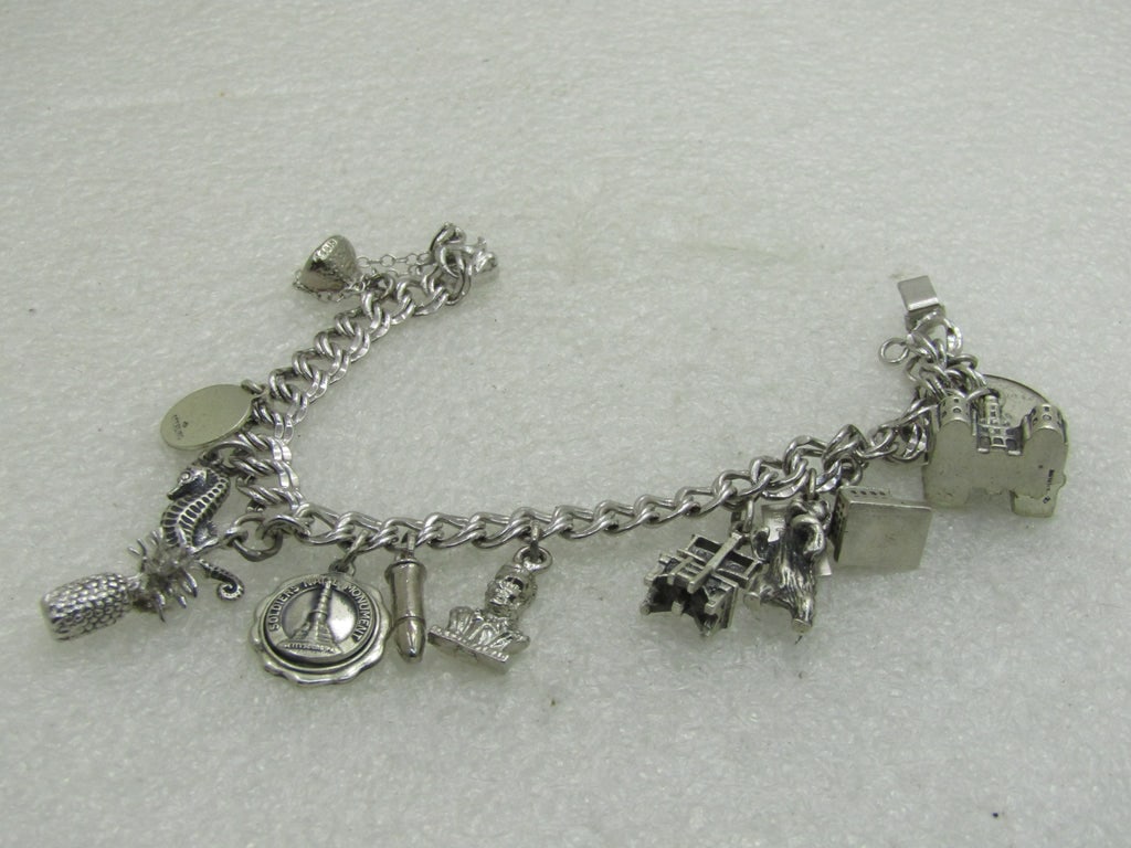 Vintage Sterling Silver Charm Bracelet, 7", Elco, 7mm Double Link, 12 Charms: Vintage Sterling Silver Charm Bracelet, 7", Elco, 7mm Double Link, 12 Charms. Weight is appx. 47.21 grams. 1960's. Charms incude: Hershey kiss,bullet, Atlantic City Convention Hall, seahorse, 3-D pine