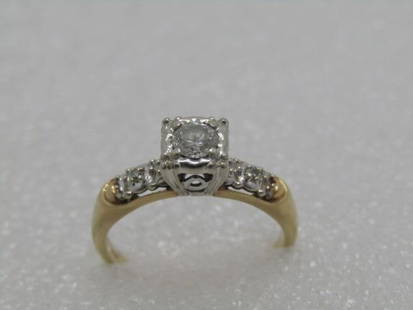 14kt Diamond Engagement Ring, .25 ctw+, size 6.5, Two-Tone, Signed D with Scroll: Vintage 14kt Diamond Engagement Ring, Size 6.5, 3.13 grams, signed with a D and a scroll passing through it. The band is yellow gold with a white gold setting for the diamonds. The main diamond sits h