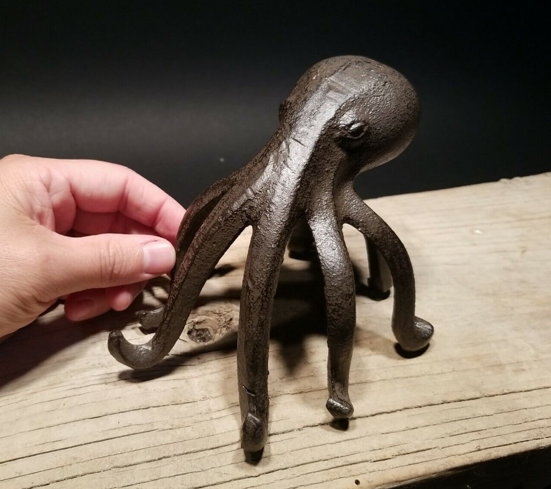 Cast Iron Octopus Phone Stand Paperweight: 4 1/2" Tall x 6" wide Introducing our charming Cast Iron Octopus Phone Holder Stand! ���� This sturdy and eye-catching piece serves as both a functional phone holder and a 
