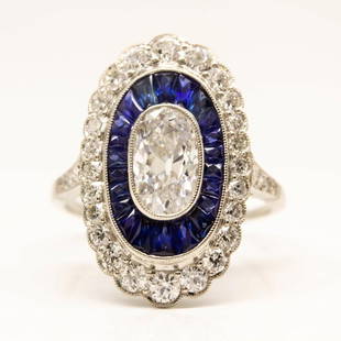 Platinum Antique Moval GIA Diamond & Calibrated Sapphire Engagement Ring: Platinum Antique Moval GIA Diamond & Calibrated Sapphire Engagement Ring Description The Mila ring is a handmade engagement ring. It centers one antique oval very rare, elongated diamond of D