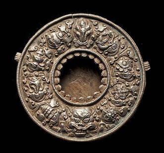 Tibet, GAU prayer box: Title: Tibet, GAU prayer box Description: Round repousse gau. silver front and side loops with brass back . Origin: Tibet Date: e. 2oth c. Dimensions: 4 1/2" Dia Material: Silver w/ brass back Reserve