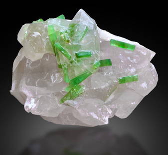 Damage Free Natural Green Tourmaline Crystals On Quartz: Treatment: None Condition: Natural Name: Tourmaline, Quartz Color: Green Weight: 1117 grams Size: 110x130x100 m.m Origin: Afghanistan Shape: Specimen Reserve: $1,500.00 Shipping:Domestic: