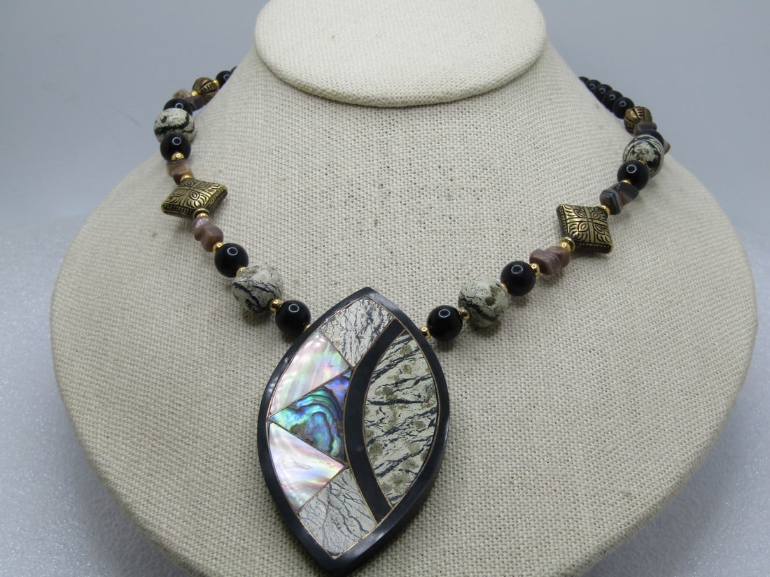 Vintage MOP Abalone Beaded Necklace, Geometric Pendant, 22", 1980's: Vintage MOP Abalone Beaded Necklace, Geometric Pendant, 22", 1980's. Black, marbled, and gold tone. The pendant is appx. 3" by 1.5" and is cateye shaped and set on the point with inlaid mother-of-pear