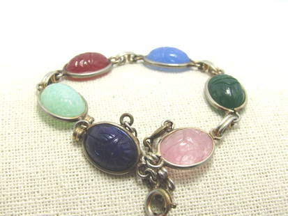 Vintage Glass Scarab Bracelet, Egyptian Retro, 7.75", Safety Chain: Vintage Scarab Egyptian Retro Bracelet with six pressed glass stones that imitate rose quartz a, blue agate, carnelian, two shades of jade, and onyx. It is 7.75" long with a spring clasp and safety cl