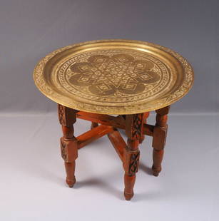 Folding Anglo-Indian Wine Coffee TABLE Brass Top Carved Legs Vintage: This quality example of the classic late 19th early 20th century Indian Brass table on a folding wood base. The table is in very good antique order. It has pleasing geometric detailing on the brass to