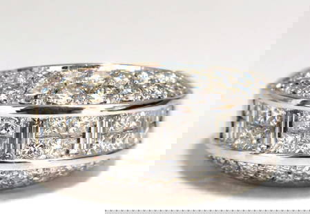 4.00ct diamonds raised contemporary ring three dimensional 18kt+: Contemporary three dimensional band. 4.00ct. Natural brilliant baguette, princess & round diamonds Vs-2 clarity G color. 18kt white gold. 11.7 Grams Overall ring: 11.5mm diameter 6.6mm depth Current r