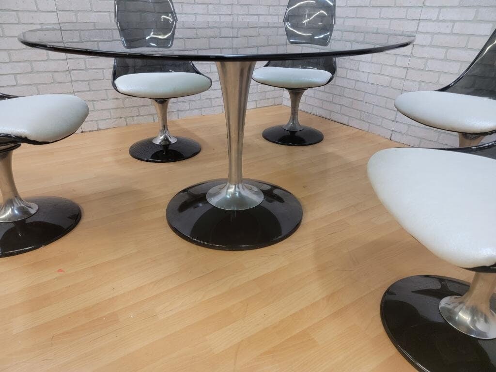 Mid Century Modern Oval Smoked Glass Tulip Dining Table by Chromcraft: Vintage from the 1970s Materials: lucite, glass, metal, aluminum Width: 60 inches Height: 29 inches Depth: 45.5 inches Description: Mid Century Modern Oval Smoked Glass Tulip Dining Table by Chromcraf
