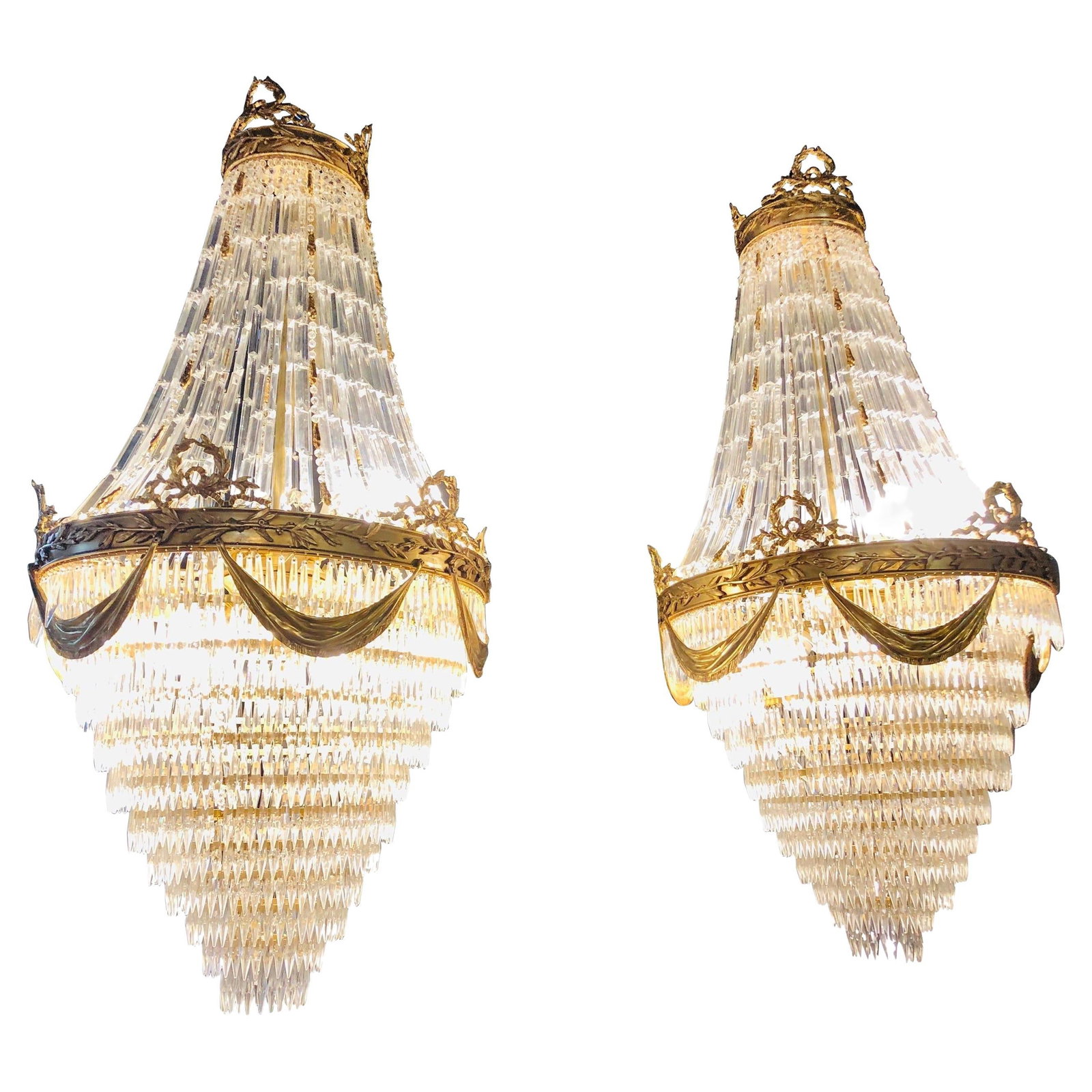 Pair of Palatial Bronze and Crystal Swag Design Louis XVI Style Chandeliers: Title: Pair of Palatial Bronze and Crystal Swag Design Louis XVI Style Chandeliers Description: Pair of spectacular palatial crystal swag design Louis XVI style chandeliers in bronze having a floral a