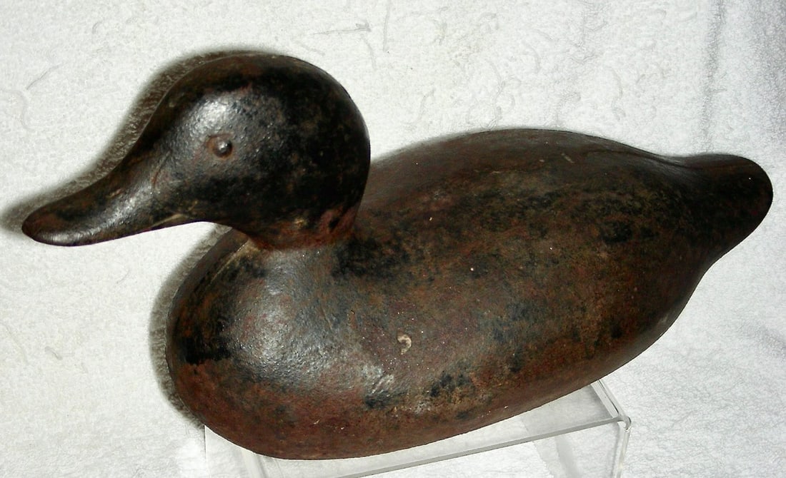Iron Sink Box Duck Decoy c.1900: A cast iron Sink Box Duck Decoy dating to the very early 20th century, or a bit older. These iron decoys were used as ballast on sink boxes or punt boats that were used for hunting waterfowl. The boat