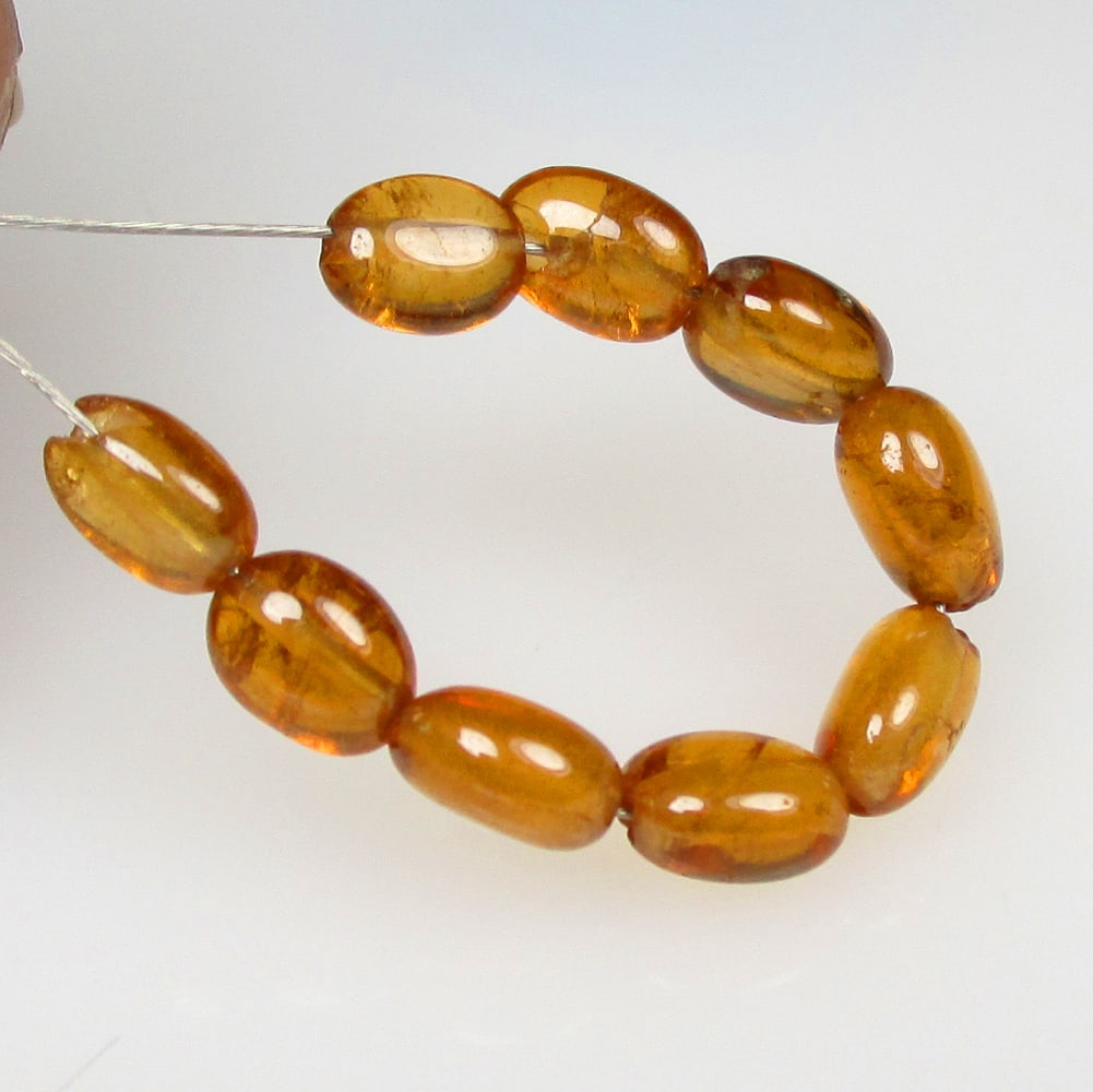 6.13 Ctw Natural 9 Hessonite Garnet Dumble Beads: No Reserve! Title: 6.13 Ctw Natural 9 Hessonite Garnet Dumble Beads Stone Clarity: Transparent Gemstones: Natural Hessonite Garnet Beads Carat Weights: 6.13 Size/Dimensions: 4.0x3.2 - 4.5x3.5 mm / 9 P