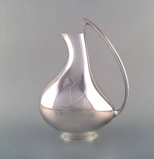 Henning Koppel for Georg Jensen. Modernist sterling silver jug. 'The Pregnant Duck'. Model number: Title: Henning Koppel for Georg Jensen. Modernist sterling silver jug. 'The Pregnant Duck'. Model number 992. Designed by Henning Koppel in 1951. Description: Henning Koppel for Georg Jensen. Modernis