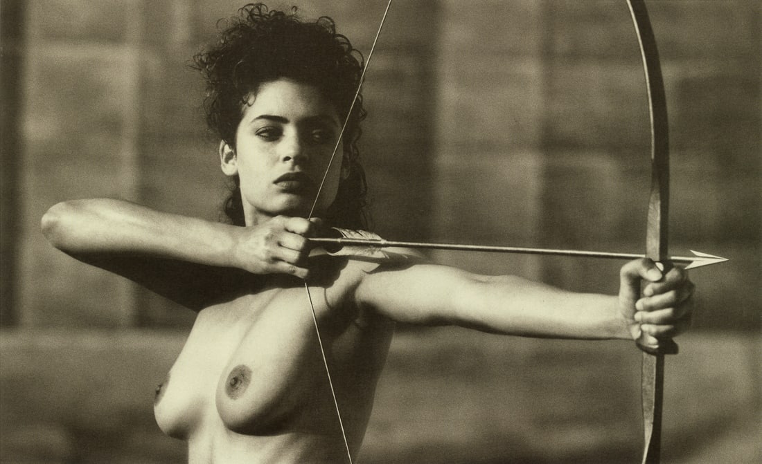 ARTHUR ELGORT - Female Figure, Bow and Arrow, 1990: Artist: Arthur Elgort Title: Female Figure with Bow and Arrow, 1990 Medium: Photo Litho, 2007, Italy Dimensions: 10.15x6.2" Description: Heat Wax Mounted on 12x14" Conservation Board Artist Bio: Arthu