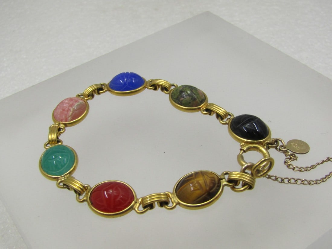 Vintage 12kt G.F. Scarab Bracelet, Signed Candita. 7/5". 1960's: Vintage 12kt G.F. Scarab Bracelet, Signed Candita. 7/5". 1960's. This seven scarabs, onyx, unakite, blue chalcedony, rhodochrosite, jadeite, carnelian, and tiger's eye. Each scarab is bezel-set with a