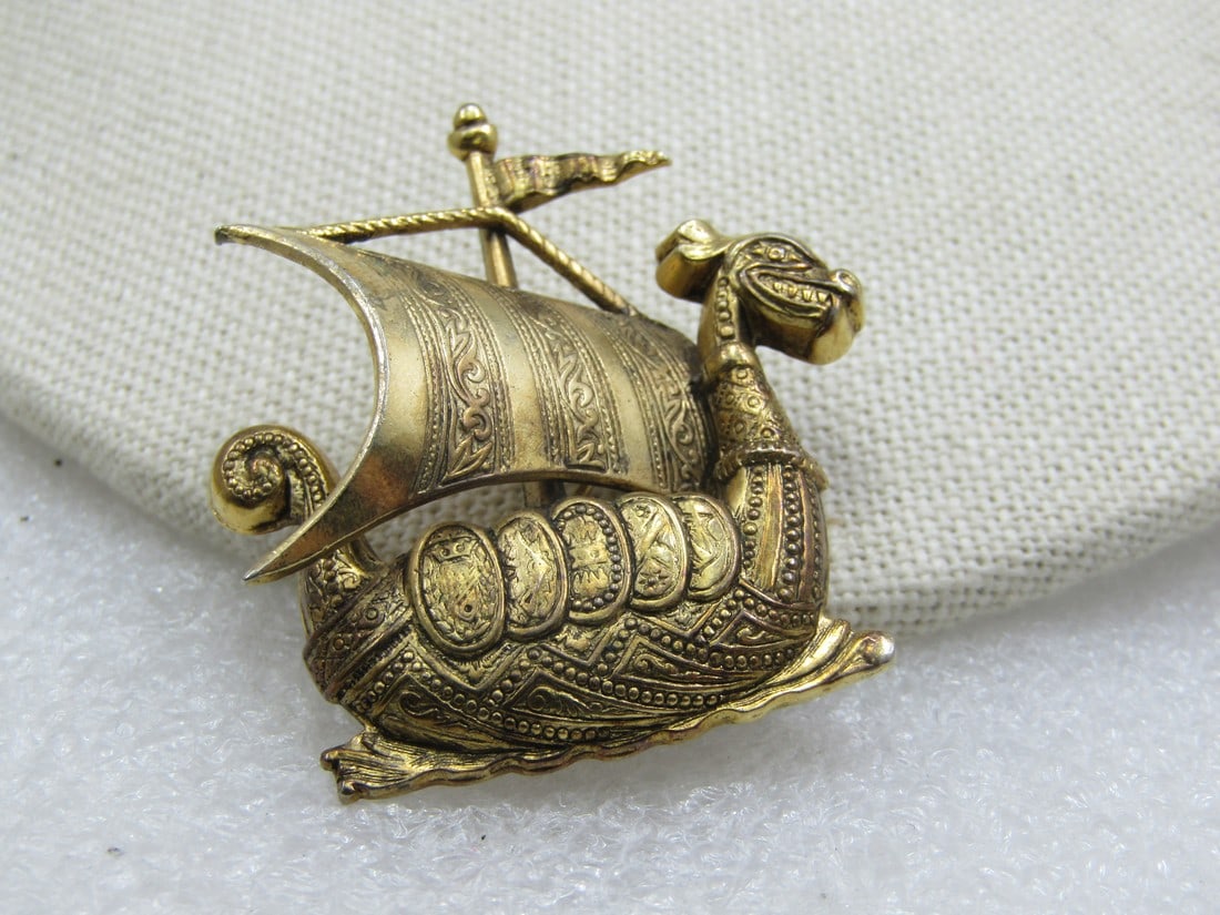 Vintage Dragon Galley Ship Brooch, Spain, Mid-Century: Vintage Dragon Sail Ship Brooch, Spain, Mid-Century, 1.75" tall by 1.5". Gold tone witha stamped design throughout the brooch - a galley ship with dragon body and large sale and flag on top. Signed Sp