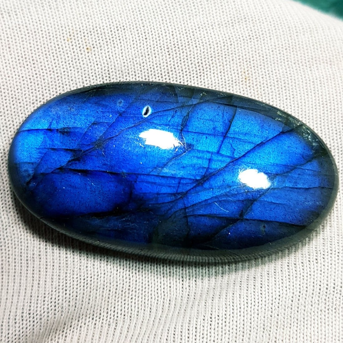 49.14 Ctz Natural Blue Labradorite: No Reserve! Title: 49.14 Ctz Natural Blue Labradorite Color/Clarity: Bluish / Semi Transparent Gemstone: Labradorite Carat Weights: 49.14 Size: 35.80 x 19.05 x 8.20 Additional Information: Oval Caboch