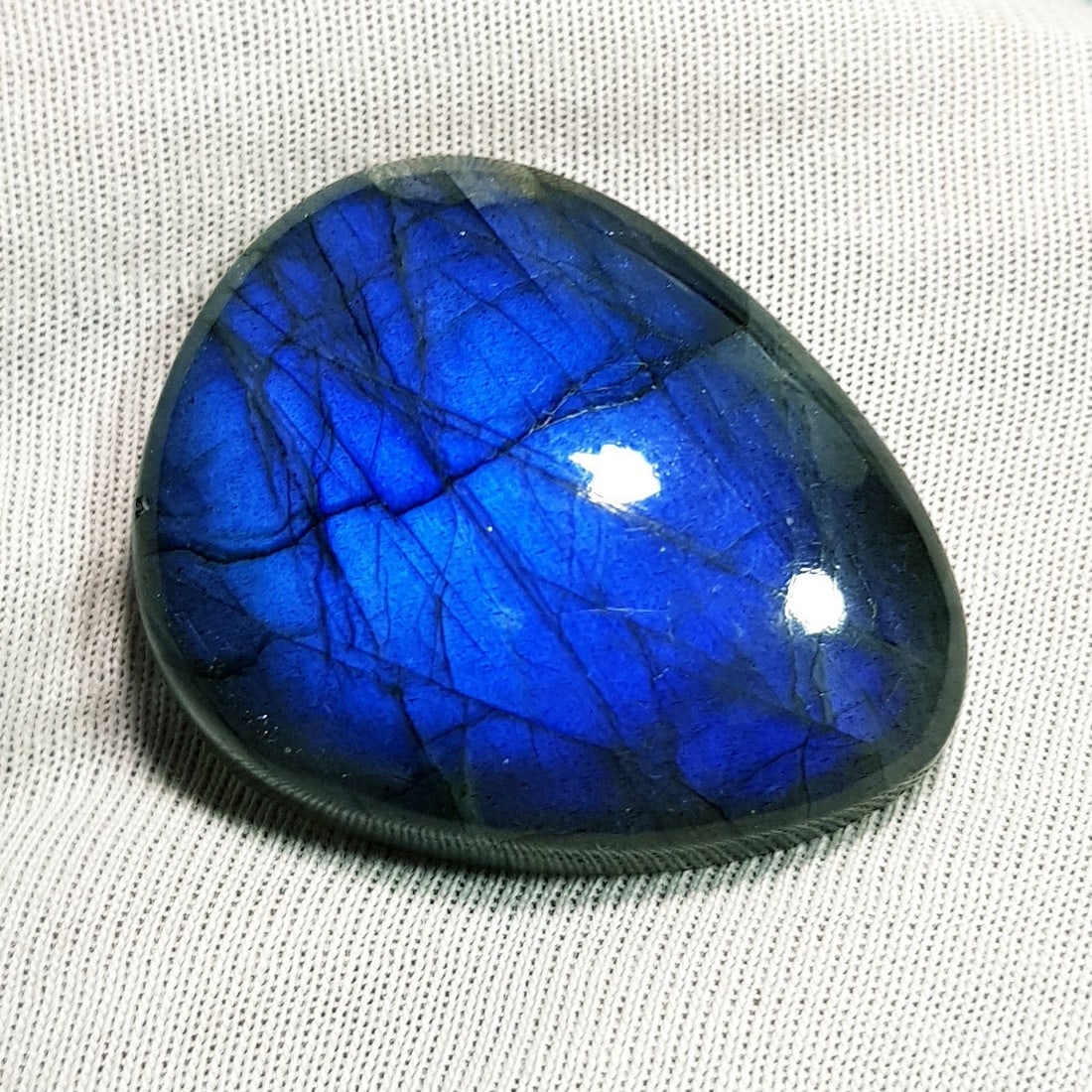 52.30 Ctz Natural Blue Labradorite: No Reserve! Title: 52.30 Ctz Natural Blue Labradorite Color/Clarity: Bluish / Semi Transparent Gemstone: Labradorite Carat Weights: 52.3 Size: 30.90 x 25.35 x 7.90 Additional Information: Pear Cabocho