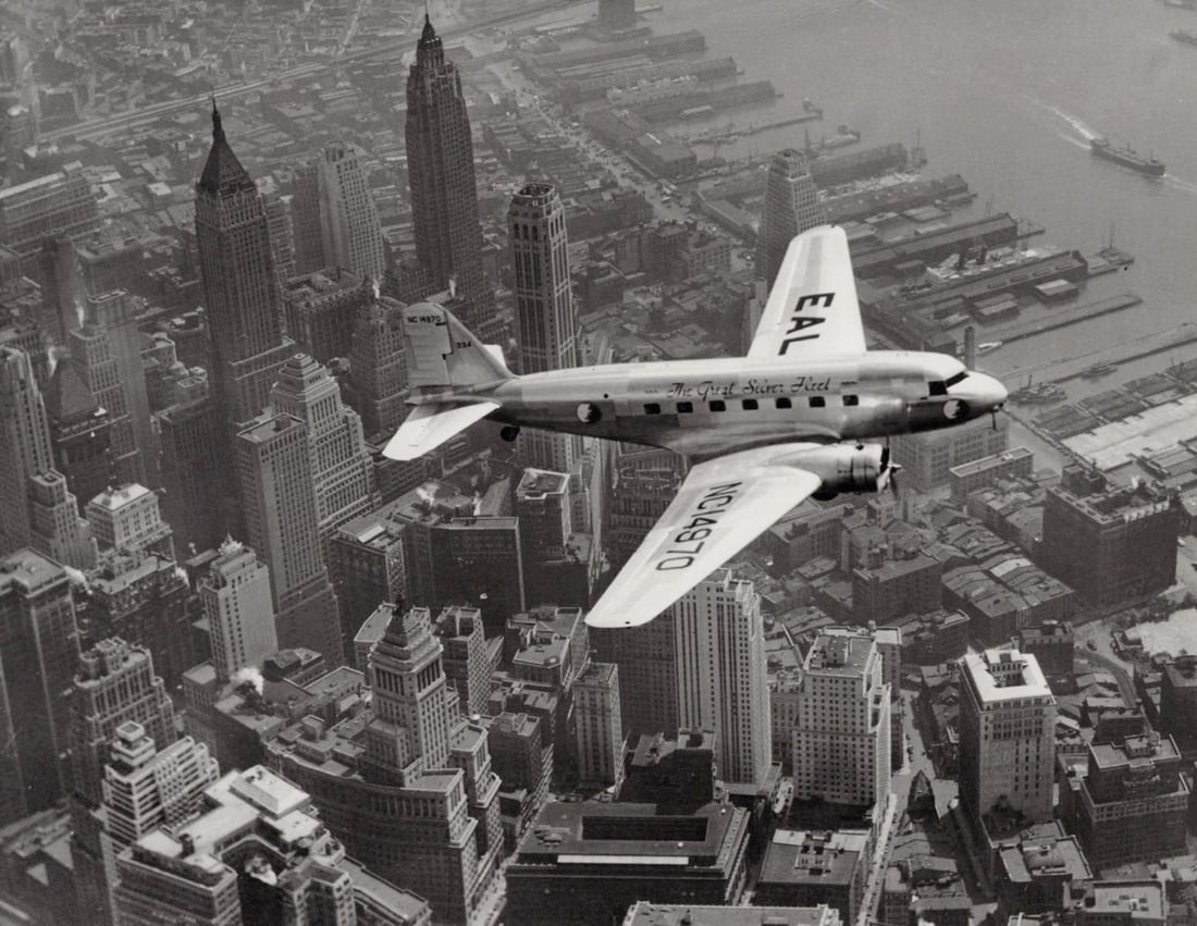 MARGARET BOURKE WHITE - Plane over Manhattan, Easter Airlines, NYC, 1934: Artist: MARGARET BOURKE WHITE Print Title: Plane over Manhattan, Easter Airlines, NYC, 1934 Printing Date: 2010s Medium:Duotone Photolithograph Printed in: the US Image Size approx: 7 x 8.5” Mar