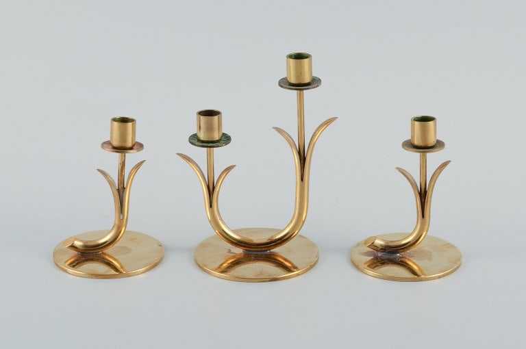Gunnar Ander for Ystad Metall. Three brass candlesticks. 1950s.: Title: Gunnar Ander for Ystad Metall. Three brass candlesticks. 1950s. Description: Gunnar Ander for Ystad Metall. Three brass candlesticks. 1950s. Largest measurement: H 12.5 x D 7.5 cm. In excellent