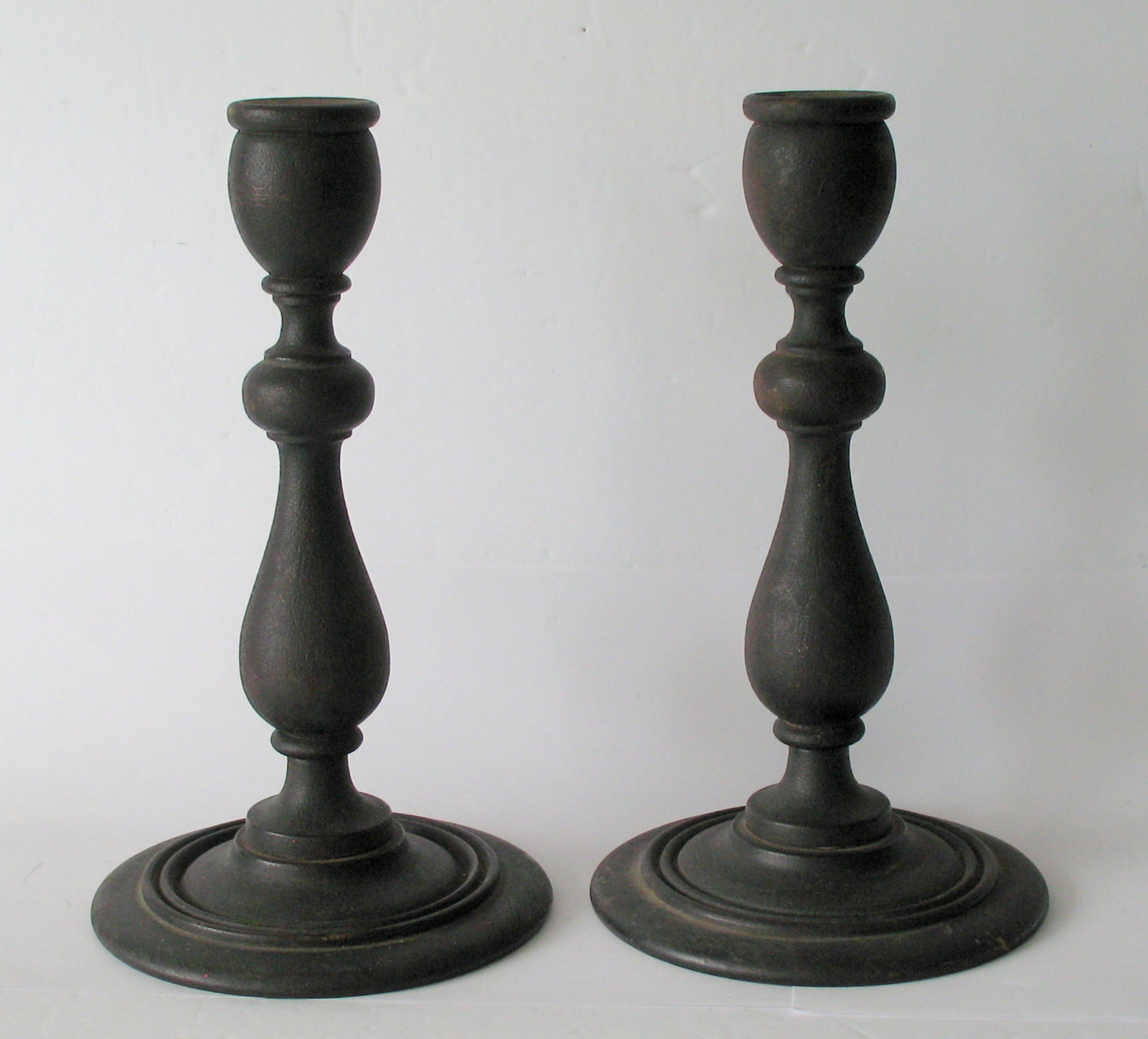 Antique New England wood candle sticks.: Title: Antique New England wood candle sticks. Date/Period: 1920's Dimension: 9” high each Additional Information: Great pair of antique New England wood candle sticks in great all original blac