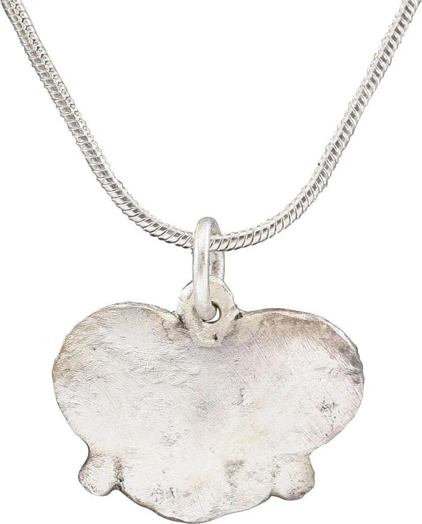 VIKING HEART PENDANT, 9TH-10TH CENTURY, DANELAW ENGLAND: Over ¾” width, made by the open-face mold technique. Silvered bronze of natural form, slightly cusped top and pointed bottom, nubs at the bottom quarter points. Plain flat field suggesting 
