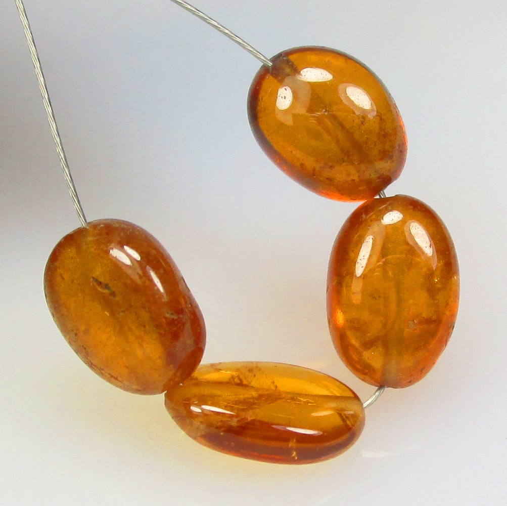 8.53 Ctw Natural 4 Hessonite Garnet Dumble Beads: No Reserve! Title: 8.53 Ctw Natural 4 Hessonite Garnet Dumble Beads Stone Clarity: Transparent Gemstone:Natural Hessonite Garnet Beads Carat Weight: 8.53 Size/Dimensions: 5.9x3.5- 6.5x3.6 mm / 4 Pc's 