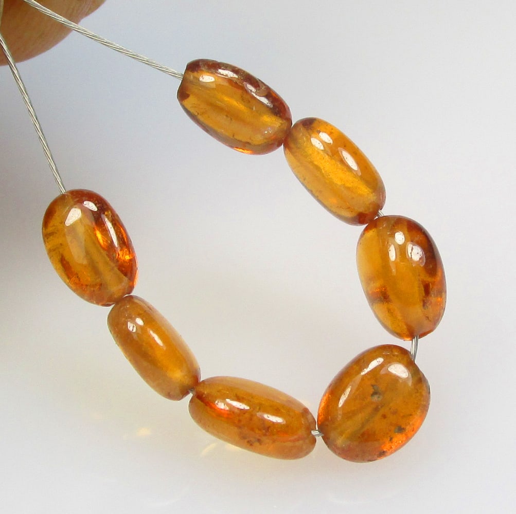 5.34 Ctw Natural 7 Hessonite Garnet Dumble Beads: No Reserve! Title: 5.34 Ctw Natural 7 Hessonite Garnet Dumble Beads Stone Clarity: Transparent Gemstone:Natural Hessonite Garnet Beads Carat Weight: 5.34 Size/Dimensions: 4.0x2.9- 4.6x3.2 mm / 7 Pc's 